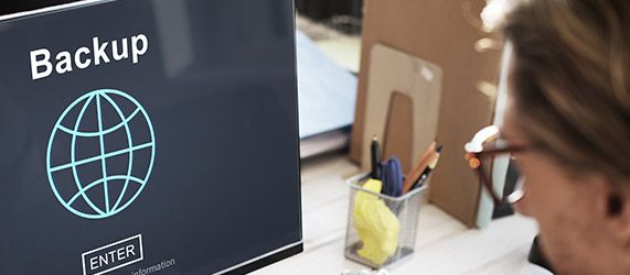 User looking at computer screen that says back up 