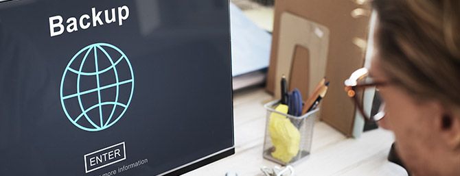 User looking at computer screen with an internet symbol that says back up and enter