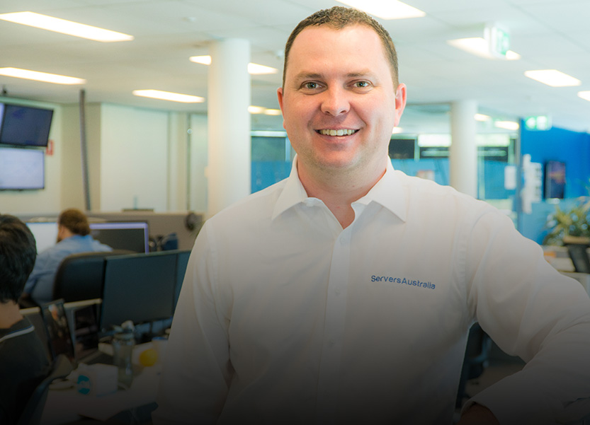 Portrait of Servers Australia Employee leaning on desk 